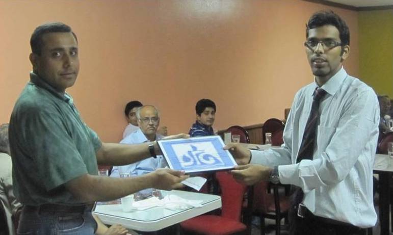 Abhijit Gangopadhyay presenting SPGNA 2011 scholarship to a student from India (Puneet Saraswat) to attend/present paper at SEG-2011
